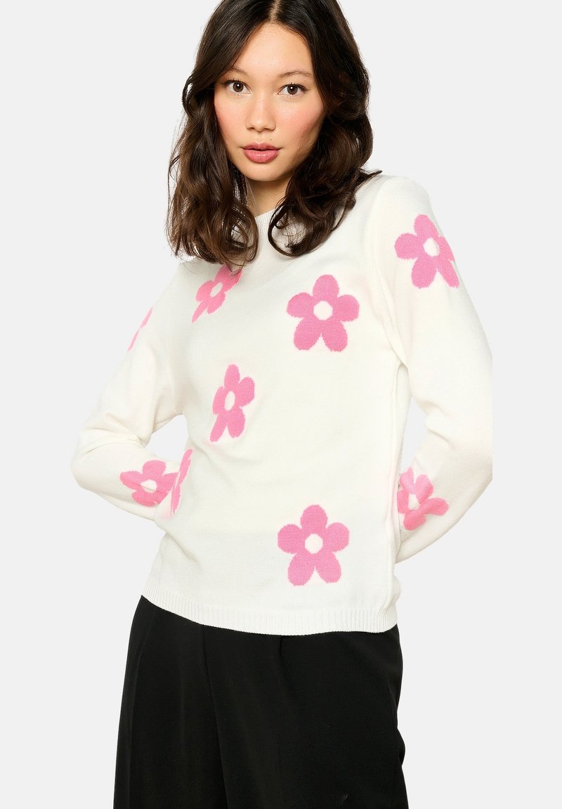 White sweater with pink floral pattern, crew neck, long sleeves, and ribbed cuffs. Soft texture, fitted design, suitable for casual wear.
