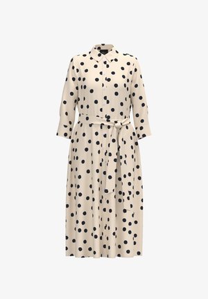 Beżowa midi sukienka koszulowa w czarne grochy, z długimi rękawami, zapięciem na guziki z przodu, kołnierzykiem i paskiem w talii wiązanym z boku.