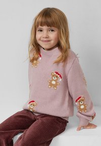 Różowy sweter wykonany na drutach z wzorem niedźwiedzi w czerwonych czapkach, połączony z brązowymi spodniami z korduroyu. Przytulny wygląd odpowiedni dla dzieci.