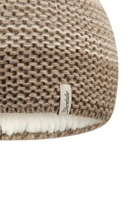 Beige and brown knit beanie with textured pattern and white fleece lining, featuring a small fabric tag labeled "Sterntaler" on the edge.