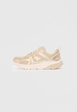 Beige mesh and synthetic sneaker with lace-up front, cushioned sole, and pull tab at heel on light gray background.