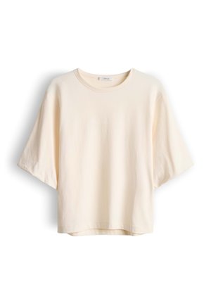 T-shirt in cotone color crema a maniche corte con scollo rotondo e vestibilità morbida, mostrata su uno sfondo bianco.