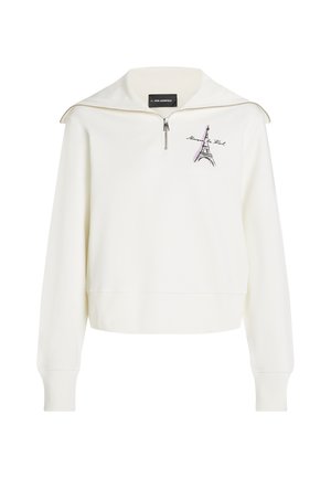 White sweatshirt with a half-zip collar, featuring a graphic of the Eiffel Tower and text. Smooth texture, relaxed fit, and ribbed cuffs.