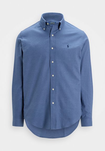 Košulja s dugim rukavima od svijetloplavog pamuka, s klasičnim ovratnikom i malim vezom logotipa na prsima.