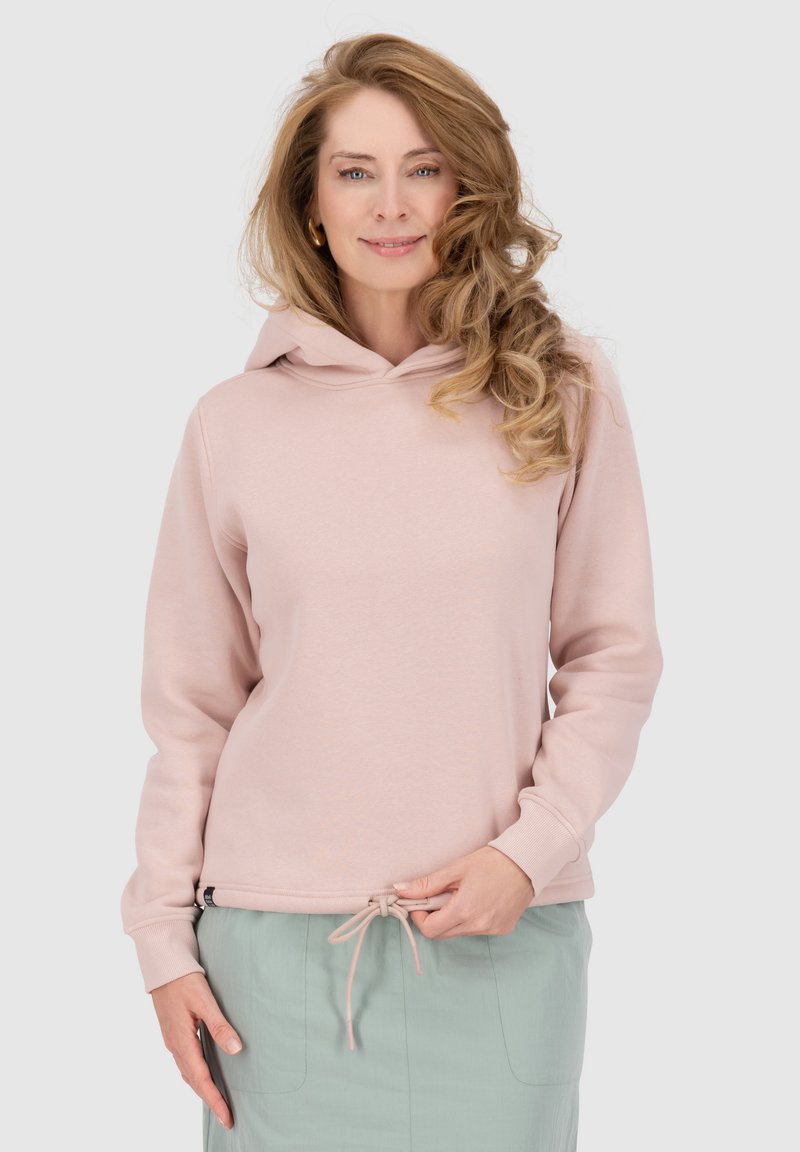 Felpa rosa chiaro con tasca a marsupio, orlo con coulisse e polsini a coste. Indossata su una gonna verde menta, caratterizzata da una vestibilità comoda.
