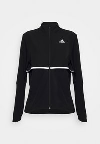 Chaqueta deportiva negra con un cuello alto, cremallera completa, una franja blanca y el logo de Adidas en el pecho. Tejido suave y elástico.