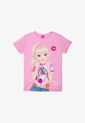 Pink cotton t-shirt featuring a graphic of a girl with blonde hair. Text "FASHION CHAOS" in black, colorful paint splashes, and a kiss mark.