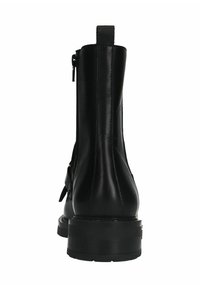 Bottes noires en cuir à talon avec une texture lisse, bout rond, semelle robuste, fermeture zippée à l'arrière et languette de tirage au talon.