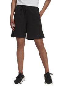 Schwarze Sweatshorts mit verstellbarem Kordelzugbund, seitlichen Taschen und einem dezenten Logo am linken Bein. Weiches Material und lockere Passform.