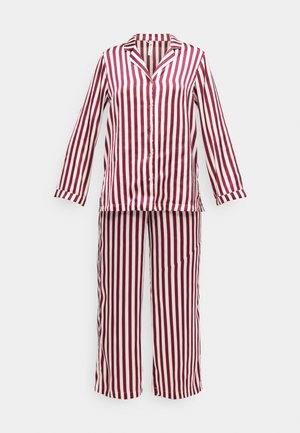 Completo pigiama a righe rosse e bianche composto da una maglia a maniche lunghe, colletto, chiusura a bottoni e pantaloni larghi con elastico in vita.