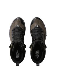 Black and brown athletic shoes with mesh upper, textured detailing, and lacing system. Features branded insoles and rubber soles.