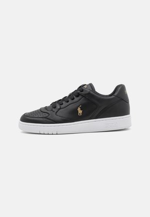 Black leather low-top sneaker with black laces, a white sole, and a small gold polo player logo on the side.