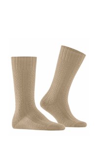 Calze a maglia beige con risvolti a coste, motivo testurizzato e punte e talloni rinforzati. Materiale morbido e design di lunghezza media fino al polpaccio.