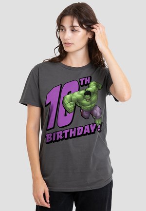 Gray cotton t-shirt featuring a graphic of a green character with the text "10th BIRTHDAY!" in bold purple lettering.