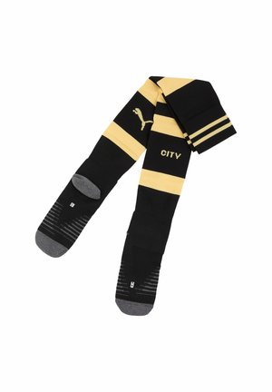 Schwarz-gelb gestreifte Sportsocken mit grauen Zehen und Fersen, mit dem Label "CITY," und einem Puma-Logo am oberen Teil.