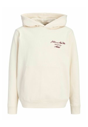 Cremefarbener Hoodie mit Fronttasche und kleinem roten Schriftzug auf der oberen linken Brust mit dem Schriftzug Madrid und weiteren Worten.