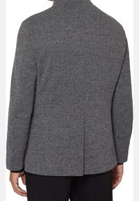 Gray herringbone blazer with a tailored fit, long sleeves, and a back vent, finished with a smooth texture and high collar.