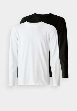 Paire de t-shirts à manches longues en noir et blanc. Fabriqués en coton, ils présentent un col rond et un logo discret sur la poitrine.