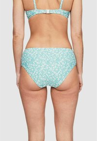 Ljusblå bikinitopp med vitt blommönster, med hög midja och slät textur. Enkel design utan synlig hårdvara.