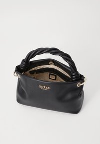 Black leather handbag with a braided handle, gold hardware accents, and a fabric-lined interior featuring a brand logo pattern.