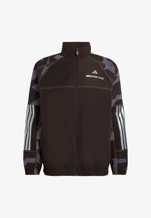 Black zip-up jacket with a high collar, featuring gray camo sleeves and reflective branding. Elastic cuffs and hem with yellow stitching accents.