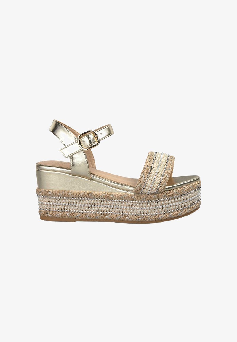 Platform sandals with a metallic gold upper, wide beaded strap, and woven jute sole. Features an ankle strap with a buckle closure.