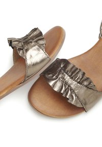 Metallic bronze sandals with a ruffle design, open-toe style, and a smooth brown footbed, featuring a flat rubber sole.