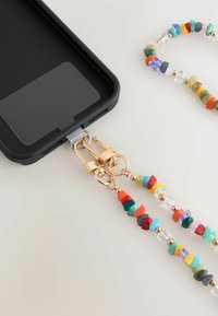 Black phone case with a clear slot, attached to a colorful beaded strap featuring gold hardware and various textured, multicolored beads.