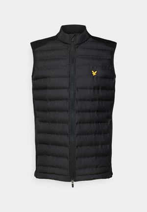 Gilet imbottito nero con colletto alto, zip frontale e logo d'aquila dorato sul lato sinistro del petto. Presenta una texture trapuntata e pannelli laterali a contrasto.