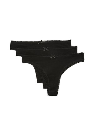 Trois strings noirs pour femmes avec bordure en dentelle et petits nœuds devant, empilés sur fond blanc.
