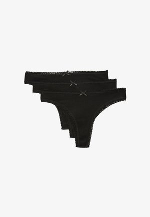 Trois strings noirs pour femmes avec bordure en dentelle et petits nœuds devant, empilés sur fond blanc.