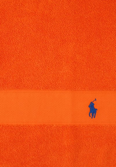 Lyseorange tekstureret håndklæde med et vandret bånd, der har en lille blå broderet polo spiller logo.