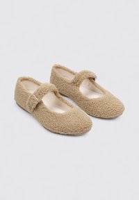 Beige, fluffy ballet flats with a rounded toe and a strap across the instep; soft texture and a durable sole.