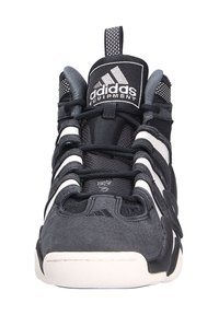 Schwarzer Sportschuh mit einem Obermaterial aus Mesh, strukturierten Überzügen und weißen Akzenten. Verfügt über einen gepolsterten Kragen und ein auffälliges Schnürsystem.