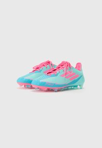 Light blue and pink soccer cleats feature a textured surface, gradient design, and prominent pink laces. Studs for traction included.