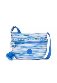Borsa a tracolla blu con motivo, dotata di un compartimento principale con zip, caratterizzata da un charm a forma di scimmia pelosa blu e un logo circolare sul fronte.