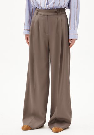 Wide-legged, high-waisted trousers made of smooth, brown fabric. Features front pleats, a side button closure, and ankle-length hem.
