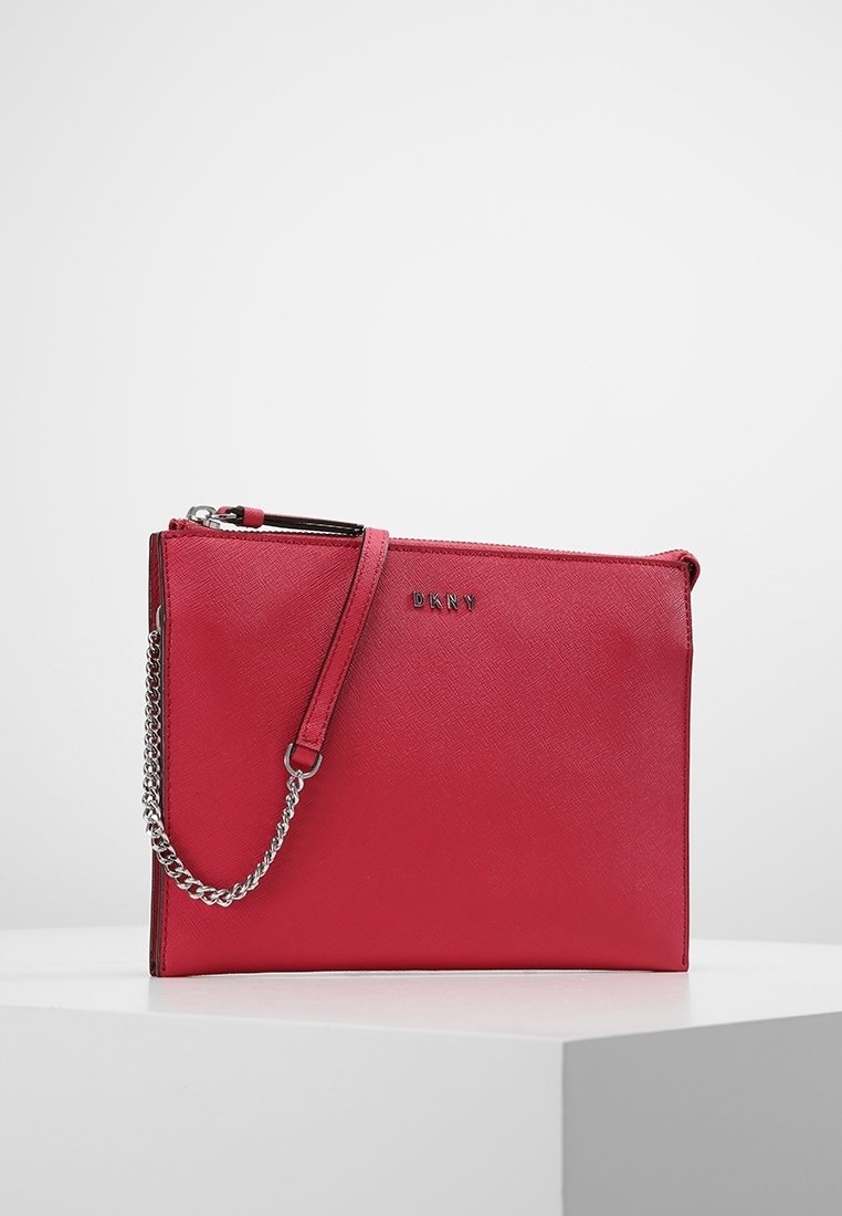 Red leather clutch with a textured finish, featuring a zipper closure and a silver chain strap. Logo embossed on the front.