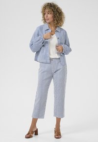 Striped blue and white jacket and pants set in cotton. Jacket features buttons and cropped design; pants are wide-leg with a cropped length.