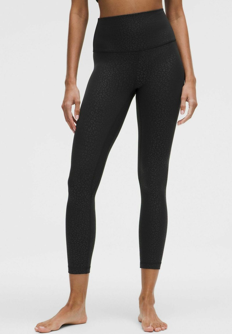 Schwarze hochgeschnittene Leggings mit strukturiertem Leopardenmuster, aus dehnbarem Material und mit einem schmalen Knöchel-Design.