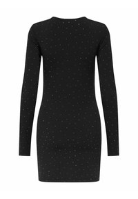 Svart långärmad klänning med en figurnära siluett, prydd med ett mönster av små silverprickar över hela. Mjuk, stretchig tyg.