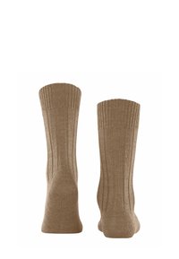 Calze beige a coste con una finitura testurizzata, dotate di un bordo, un tallone e una punta rinforzati. Design semplice, adatto per l'uso quotidiano.