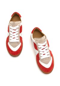 Red and white sneakers with suede and leather materials. Features a rounded toe, white laces, and a brown rubber sole.