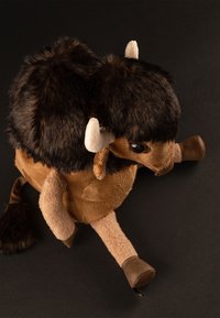 Brown plush stuffed bison with dark fur on the back, soft tan body, small horns, round face, and black eyes. Features short legs and a tail.