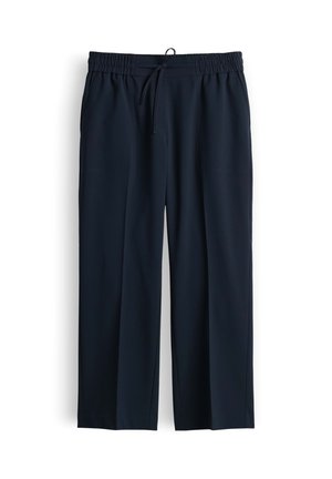 Pantaloni da uomo neri con vita elastica, coulisse regolabile e gamba dritta, esposti appesi su sfondo bianco.