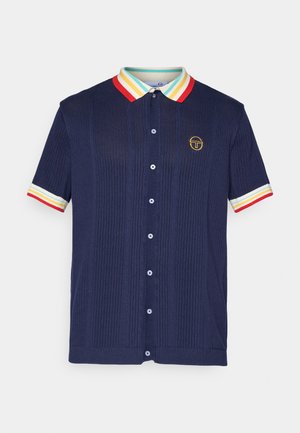 Navy short-sleeve polo shirt with a ribbed texture, multi-colored striped collar, and cuffs, featuring a small embroidered logo on the chest.