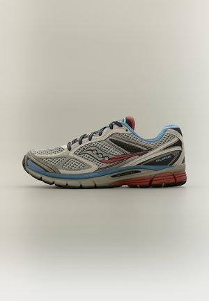 Light gray running shoe with black and red details, blue lining, and thick sole labeled "Guide 7" and "ProGrid" displayed sideways.