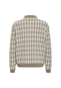 Pull à manches longues avec un motif à carreaux beige et blanc, bord-côtes aux poignets, à l’ourlet et au col, vu de dos.