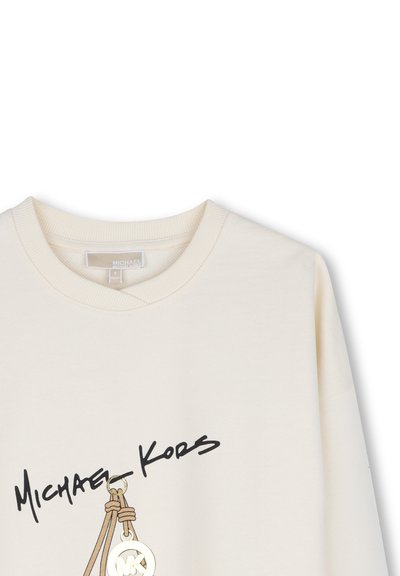 Μπεζ φούτερ Michael Kors με στρογγυλή λαιμόκοψη και μαύρο λογότυπο πάνω από γραφικό κλειδί σε χρυσό και ταμπόν χρώμα.