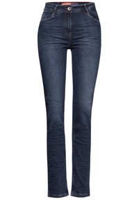 Jeans skinny en denim bleu foncé avec une texture subtile, cinq poches, fermeture avant à boutons et coutures ton sur ton. Pas de motifs ou d'accents visibles.